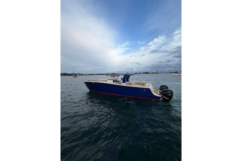 Slide: The Image of 2024 Custom Catamaran SET CAT on water, featuring sleek blue design and twin Mercury engines. - 108