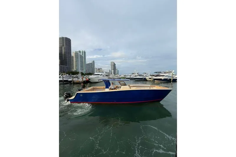 Slide: The Image of 2024 Custom Catamaran SET CAT in marina, city skyline background. - 11
