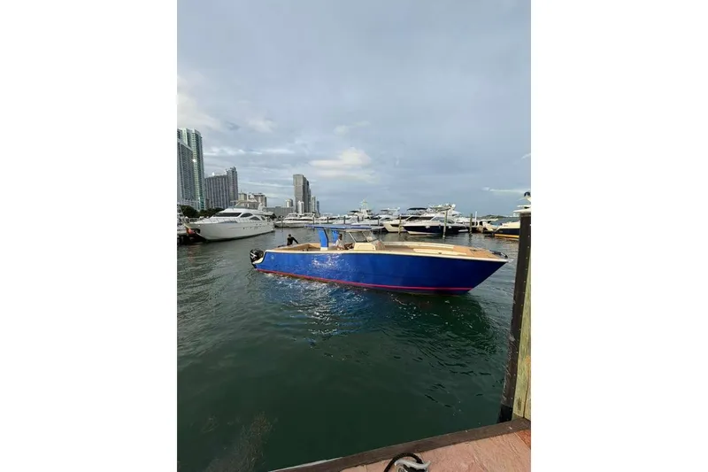 Slide: The Image of 2024 Custom Catamaran SET CAT in marina, surrounded by modern cityscape and other boats. - 110