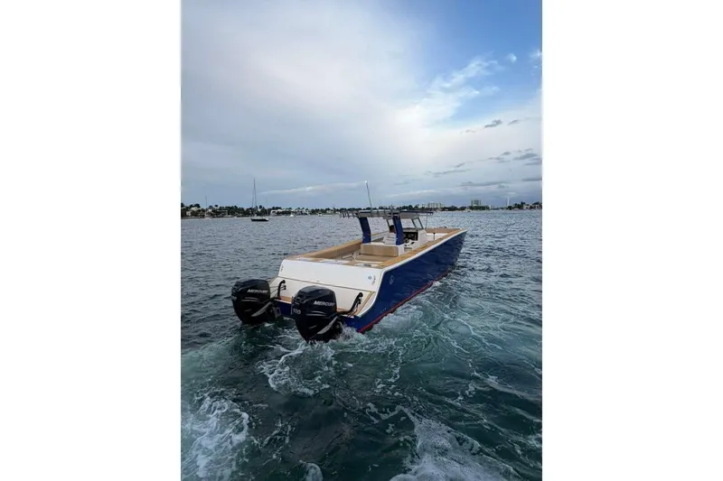 Slide: The Image of 2024 Custom Catamaran SET CAT with dual Mercury engines cruising on open water. - 111