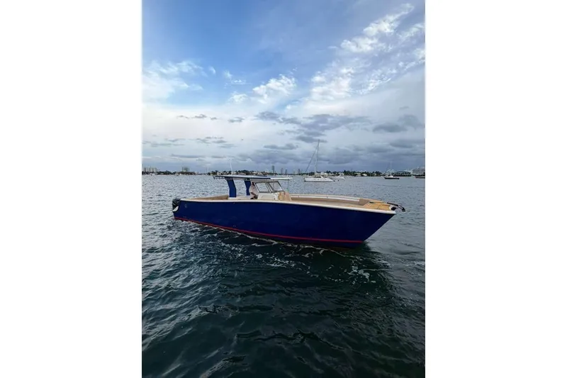 Slide: The Image of 2024 Custom Catamaran SET CAT on calm waters under a cloudy sky. - 115