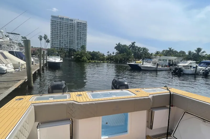 Slide: The Image of 2024 Custom Catamaran SET CAT docked in a marina with surrounding boats and buildings. - 116