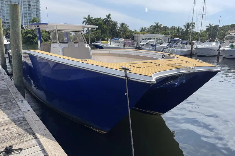 Slide: The Image of Custom 2024 Catamaran SET CAT docked, featuring sleek blue hull and spacious deck. - 117