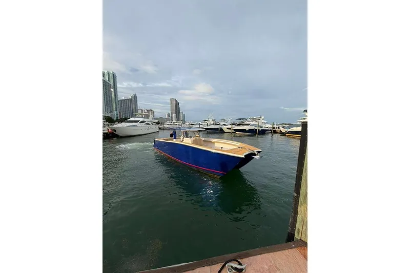 Slide: The Image of 2024 Custom Catamaran SET CAT in marina, surrounded by modern cityscape and other boats. - 14