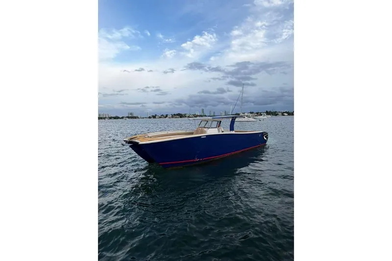 Slide: The Image of Custom 2024 Catamaran SET CAT on calm waters under a cloudy sky. - 17