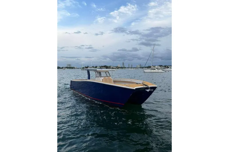 Slide: The Image of Custom 2024 Catamaran SET CAT on calm waters under cloudy sky. - 21