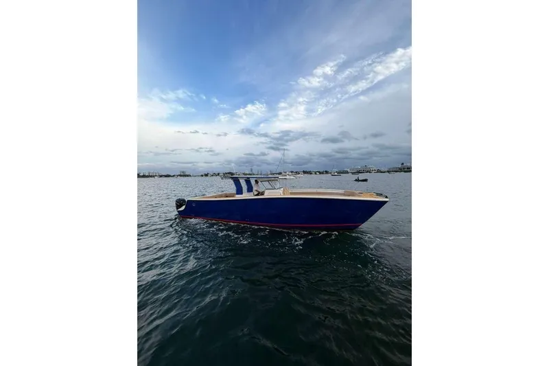 Slide: The Image of Custom 2024 Catamaran SET CAT on calm waters under a cloudy sky. - 22