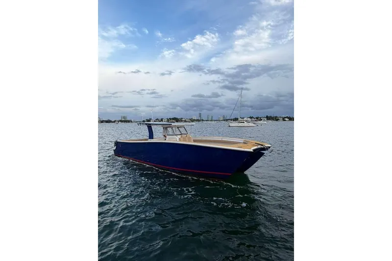 Slide: The Image of 2024 Custom Catamaran SET CAT on calm waters under a cloudy sky. - 24