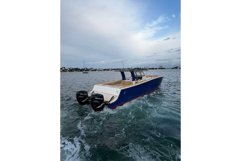 Slide: The Image of 2024 Custom Catamaran SET CAT with dual Mercury engines on open water. - 27