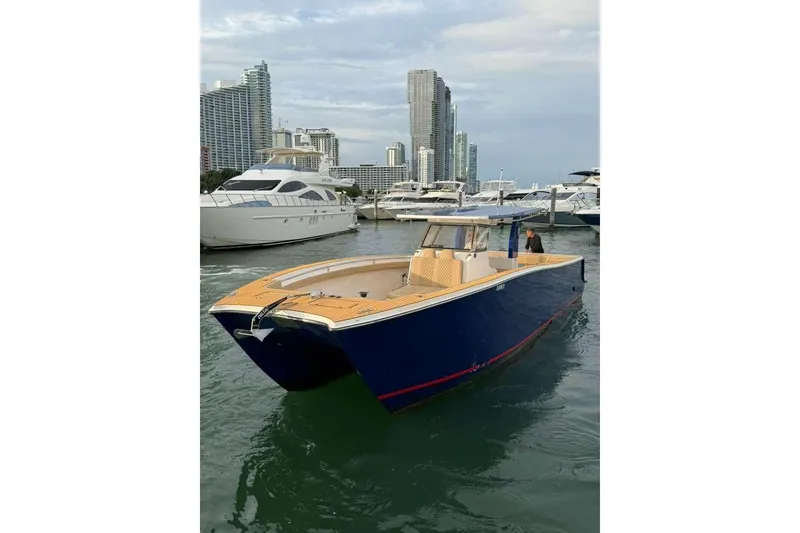 Slide: The Image of 2024 Custom Catamaran SET CAT in marina, with city skyline and yachts in background. - 28