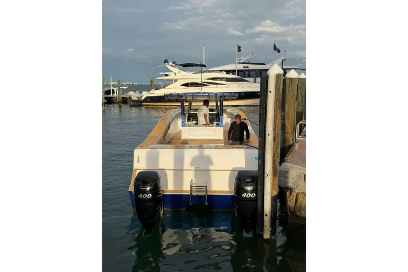 Slide: The Image of 2024 Custom Catamaran SET CAT docked with dual 400 engines in a marina. - 31