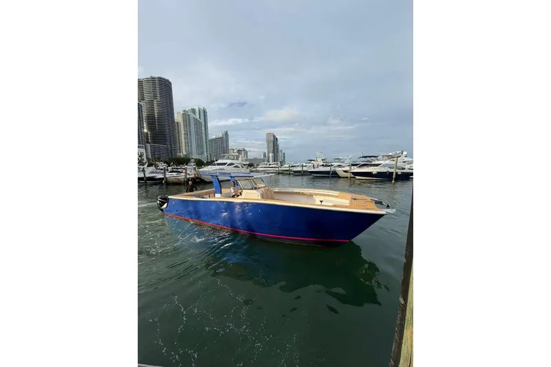 Slide: The Image of 2024 Custom Catamaran SET CAT in marina, city skyline background. - 35