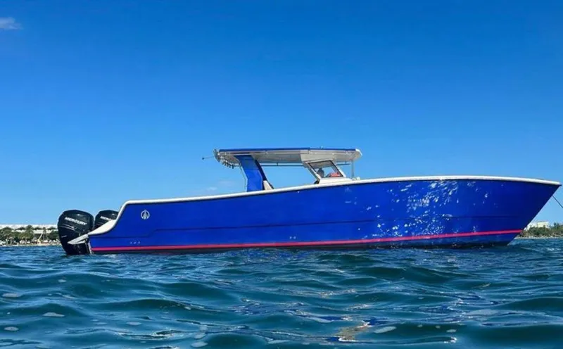 Slide: The Image of Blue 2023 Custom Catamaran Sec CatFish 39 on open water under clear sky. - 4