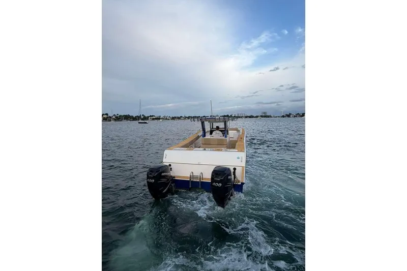 Slide: The Image of 2024 Custom Catamaran SET CAT on water, featuring dual outboard motors. - 40