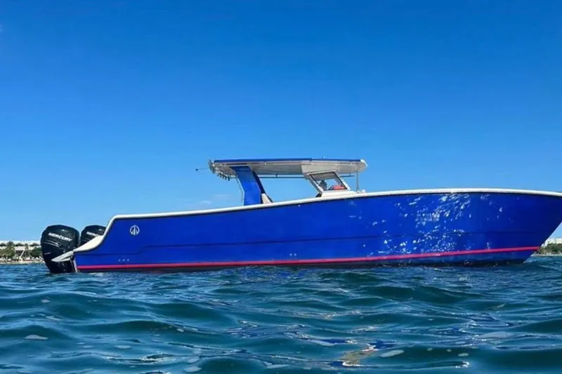 Slide: The Image of 2024 Custom Catamaran SET CAT on water, vibrant blue hull, clear sky background. - 41