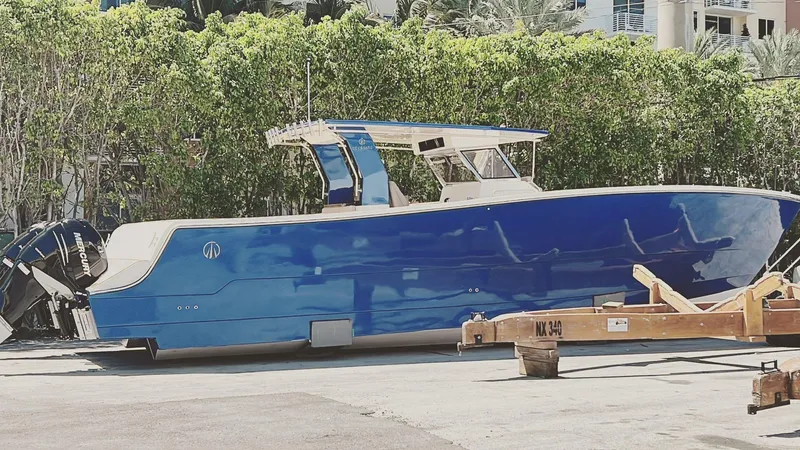 Slide: The Image of Custom Catamaran Sec CatFish 39, 2023 model, blue hull, docked outdoors. - 5