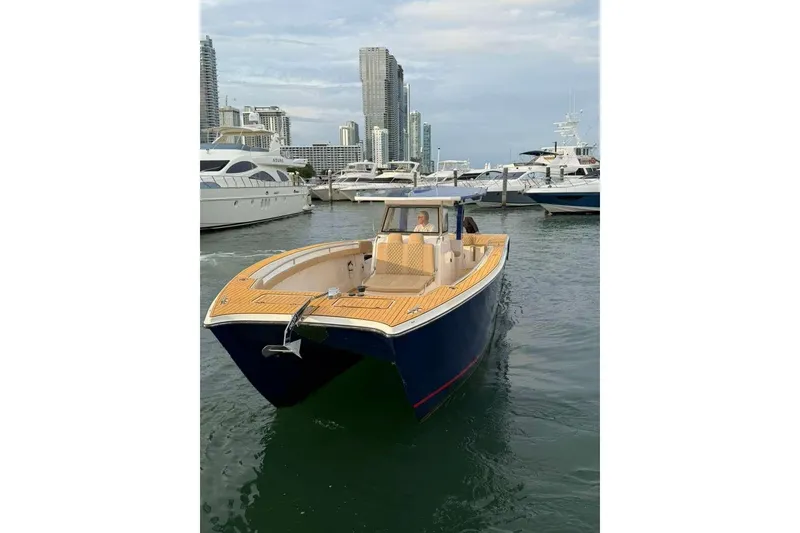 Slide: The Image of Custom 2024 Catamaran SET CAT in marina, surrounded by yachts and city skyline. - 53