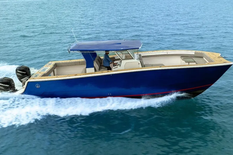 Slide: The Image of 2024 Custom Catamaran SET CAT cruising on open water, featuring sleek blue design. - 55