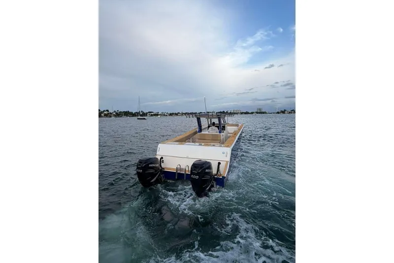 Slide: The Image of Custom 2024 Catamaran SET CAT cruising on open water with dual outboard motors. - 59