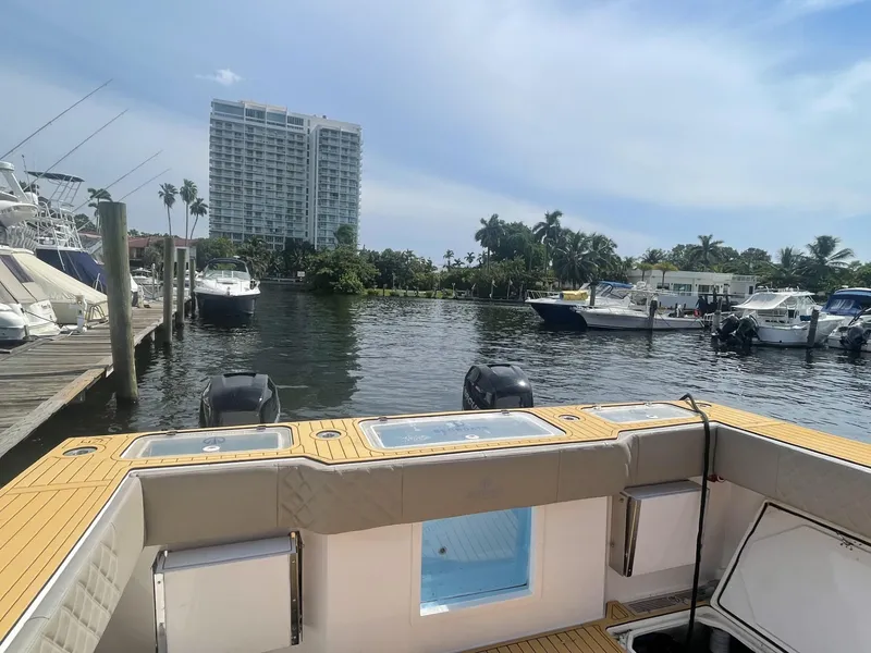 Slide: The Image of Custom Catamaran Sec CatFish 39, 2023, docked in a marina with scenic waterfront view. - 6