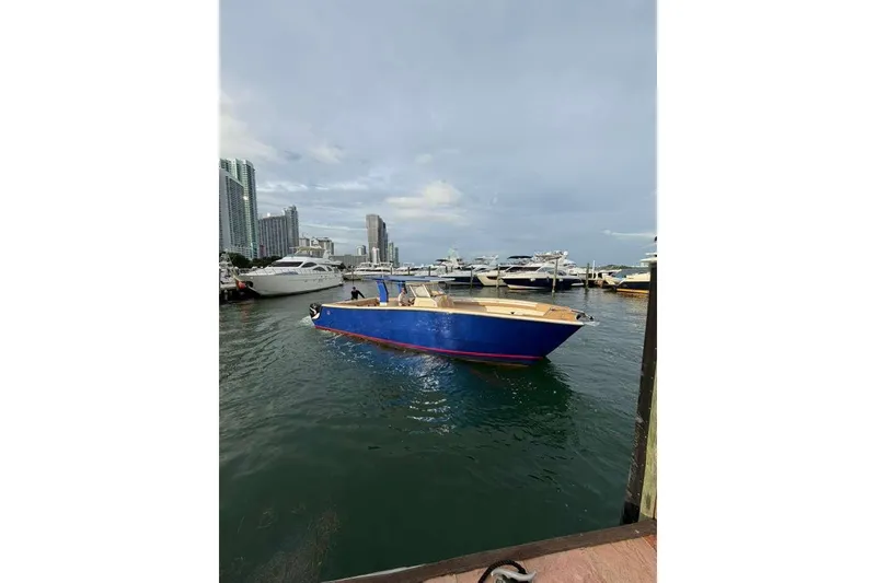 Slide: The Image of 2024 Custom Catamaran SET CAT in marina, surrounded by yachts and city skyline. - 65