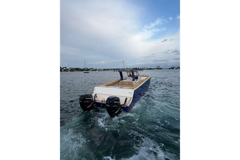 Slide: The Image of 2024 Custom Catamaran SET CAT cruising on open water with dual Mercury engines. - 66