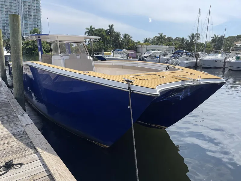 Slide: The Image of Custom Catamaran Sec CatFish 39, 2023 model, docked in a marina. - 7