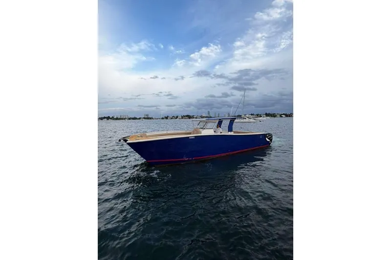 Slide: The Image of 2024 Custom Catamaran SET CAT on calm waters under a cloudy sky. - 71