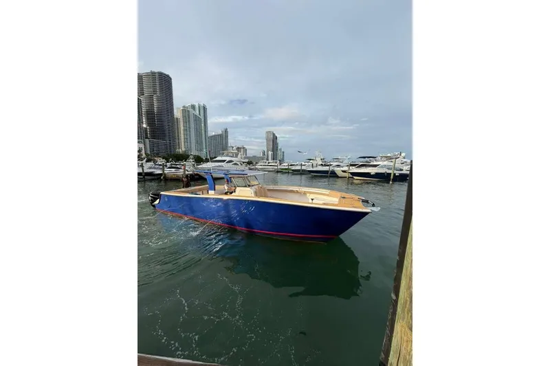 Slide: The Image of Custom 2024 Catamaran SET CAT docked in marina, city skyline in background. - 72