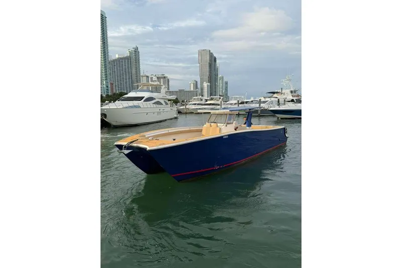 Slide: The Image of Custom 2024 Catamaran SET CAT docked in marina, surrounded by skyscrapers and yachts. - 74