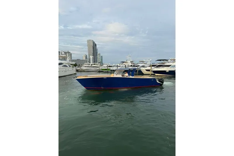 Slide: The Image of 2024 Custom Catamaran SET CAT in marina, surrounded by yachts, city skyline in background. - 75