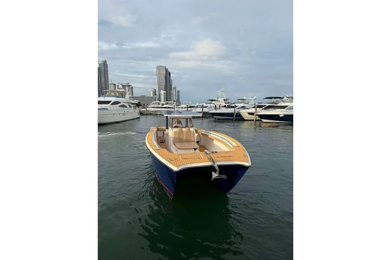 Slide: The Image of 2024 Custom Catamaran SET CAT in marina, surrounded by yachts and city skyline. - 82