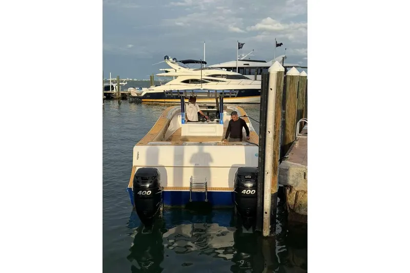 Slide: The Image of 2024 Custom Catamaran SET CAT docked with dual 400 engines, sunny day. - 89