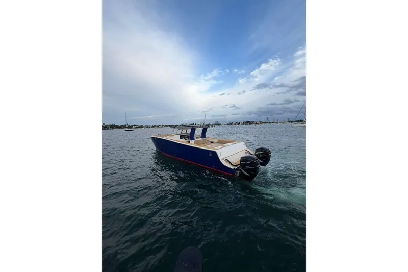 Slide: The Image of 2024 Custom Catamaran SET CAT on water, featuring dual Mercury outboard engines. - 90