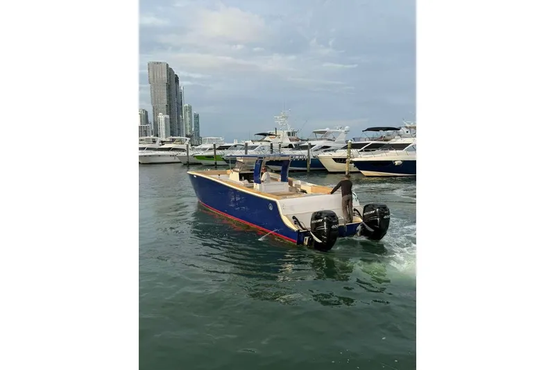 Slide: The Image of Custom 2024 Catamaran SET CAT in marina, with city skyline and yachts in background. - 95