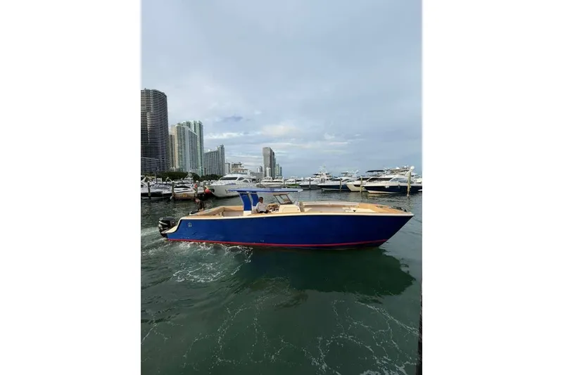 Slide: The Image of 2024 Custom Catamaran SET CAT in marina, city skyline background. - 98