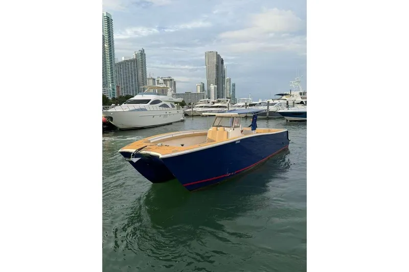 Slide: The Image of Custom 2024 Catamaran SET CAT in marina, surrounded by skyscrapers and yachts. - 99