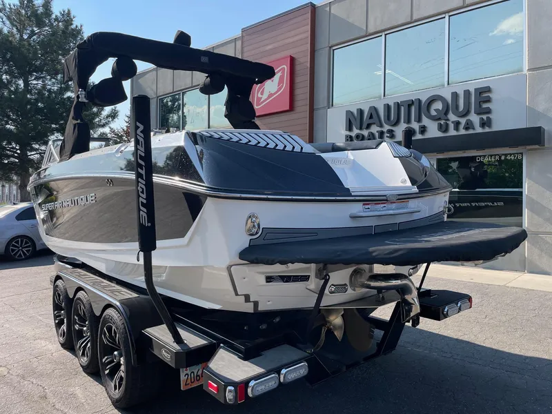 Slide: The Image of 2017 Nautique Super Air Nautique G25 boat on trailer outside dealership. - 3