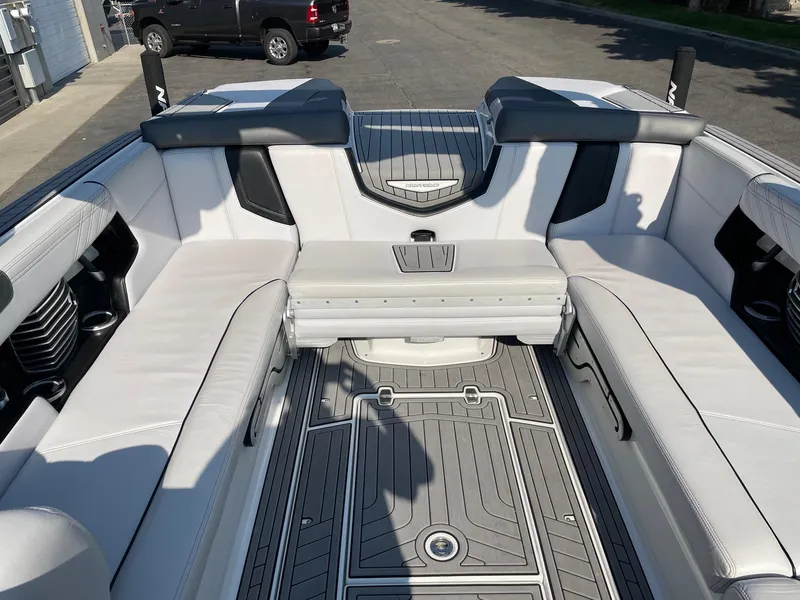 Slide: The Image of 2017 Nautique Super Air Nautique G25 interior with white seating and gray flooring. - 8