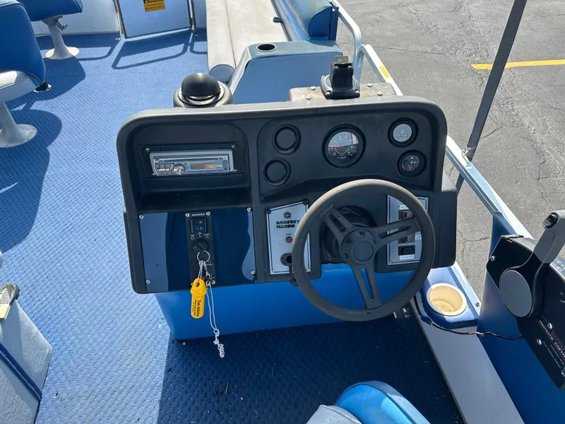 Slide: The Image of Control panel of a 1989 AquaPatio 24 boat with steering wheel and gauges. - 12