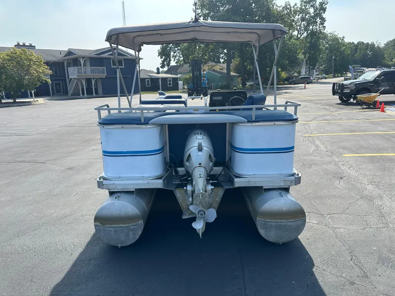 Slide: The Image of 1989 AquaPatio 24 pontoon boat with canopy in a parking lot. - 3