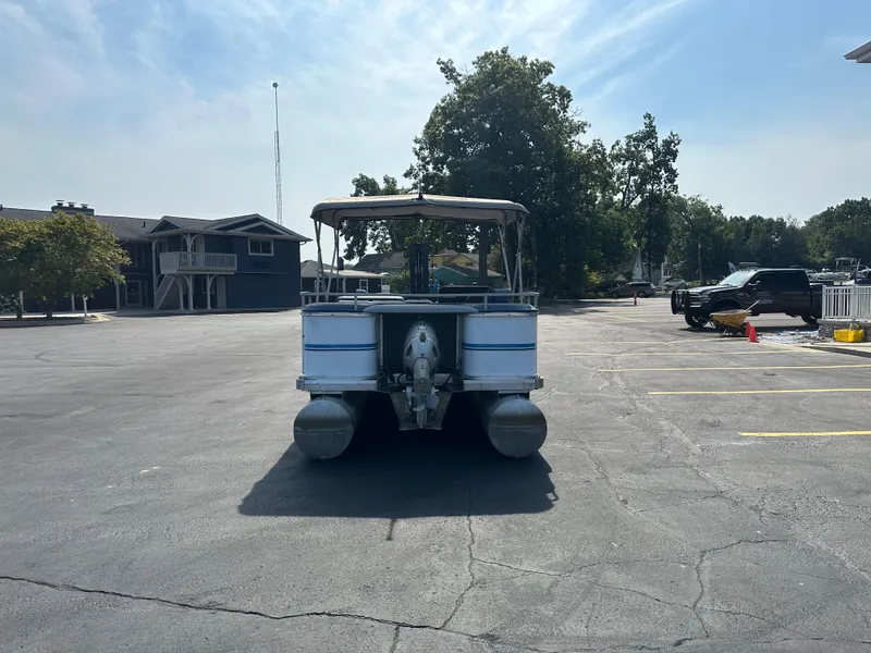Slide: The Image of 1989 AquaPatio 24 pontoon boat parked in a sunny lot. - 6