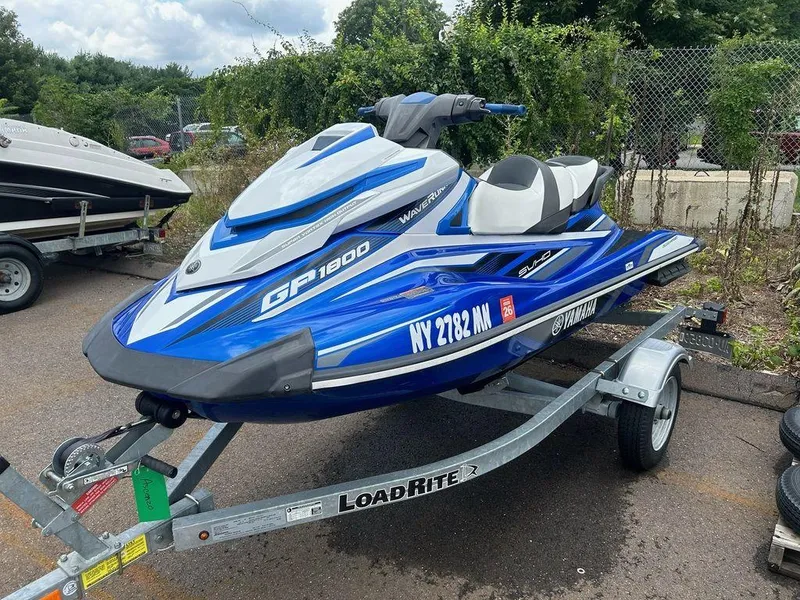 Slide: The Image of 2017 Yamaha WaveRunner GP1800 on trailer, blue and white, parked outdoors. - 3