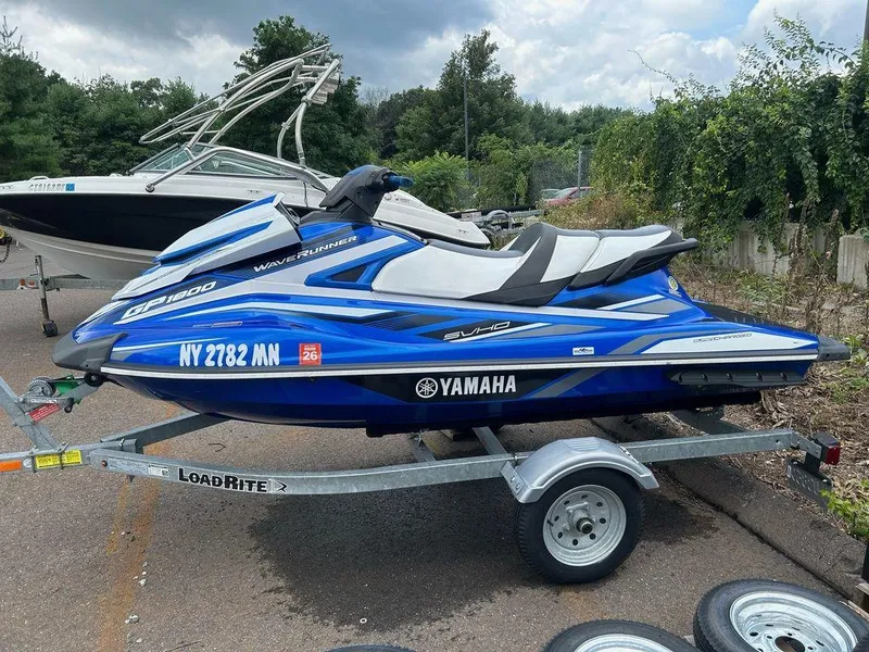 Slide: The Image of 2017 Yamaha WaveRunner GP1800 on trailer, blue and white, parked outdoors. - 4