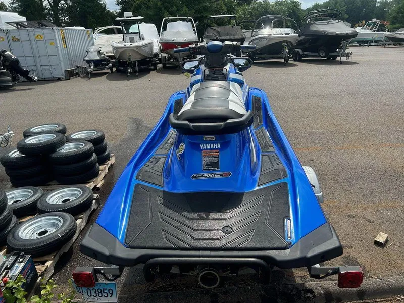 Slide: The Image of 2017 Yamaha WaveRunner GP1800 in blue, parked in a lot with other boats. - 6
