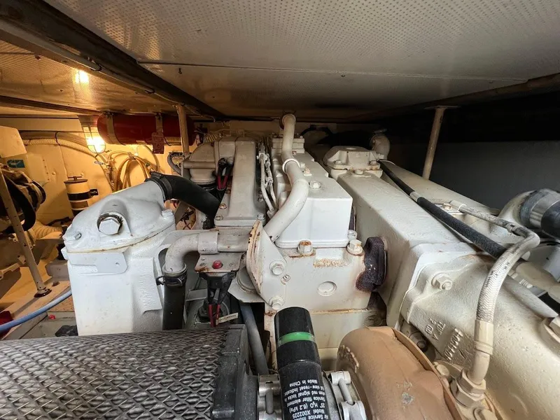 Slide: The Image of Engine room of a 1987 Ocean Yachts Super Sport, showcasing mechanical components and piping. - 30