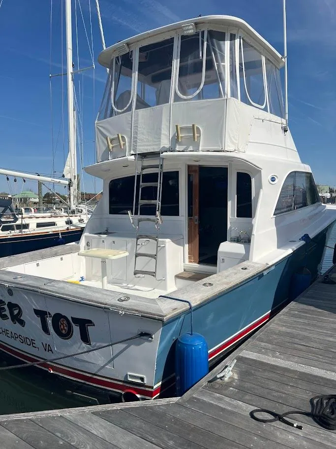 Slide: The Image of 1987 Ocean Yachts Super Sport docked, featuring a spacious deck and enclosed flybridge. - 36