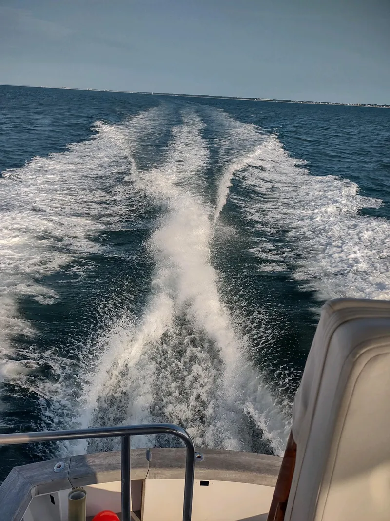 Slide: The Image of Ocean Yachts 1987 44 Super Sport cruising, leaving a wake on open water. - 39