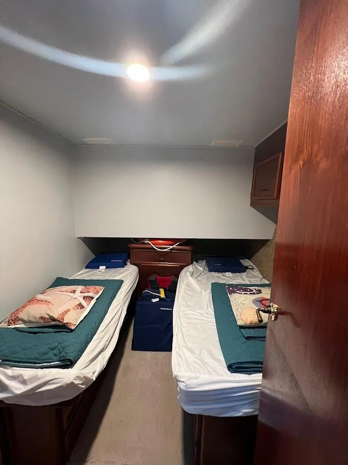 Slide: The Image of 1987 Ocean Yachts Super Sport cabin with twin beds and cozy decor. - 9