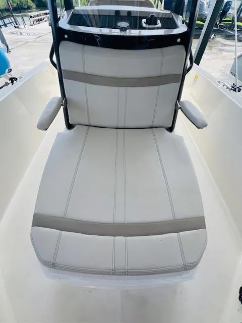 Slide: The Image of 2023 Boston Whaler 250 Dauntless boat seat with armrests, white and gray upholstery. - 13